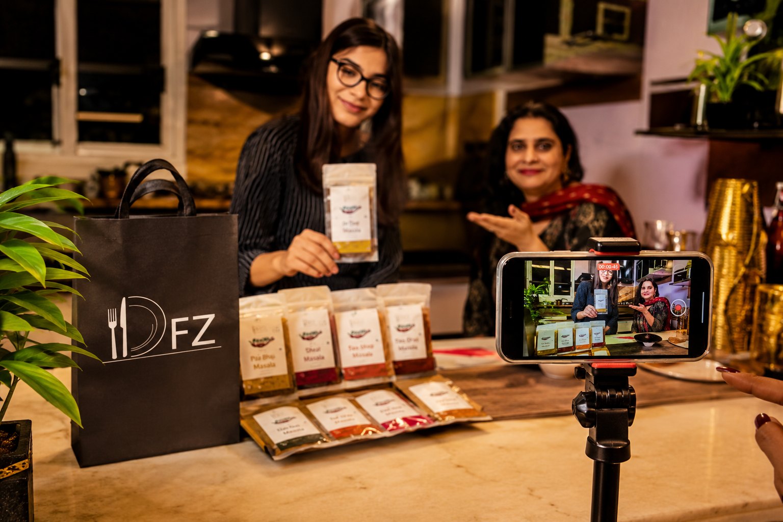 Creators filming a product reel with real products in a home kitchen